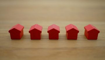 Row of red wooden tiny houses in a line 1920