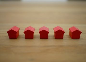 Row of red wooden tiny houses in a line 640