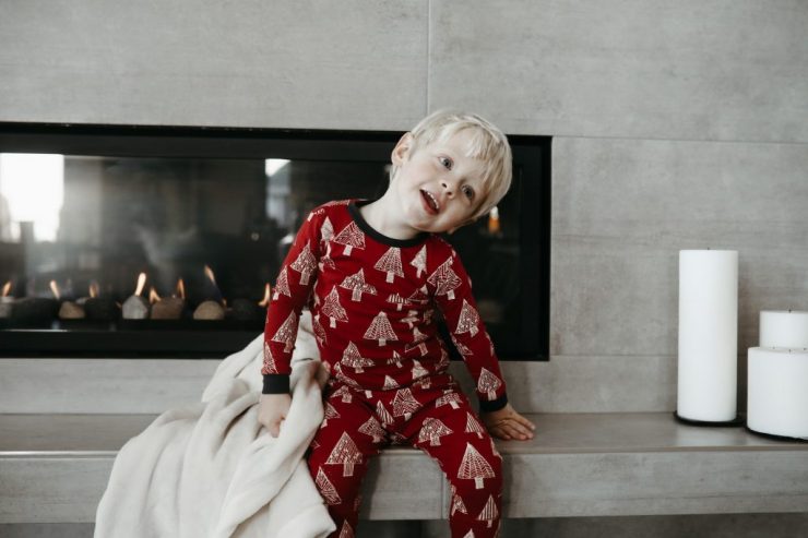 Toddler in pyjamas in front of glass fronted gas fire 1920